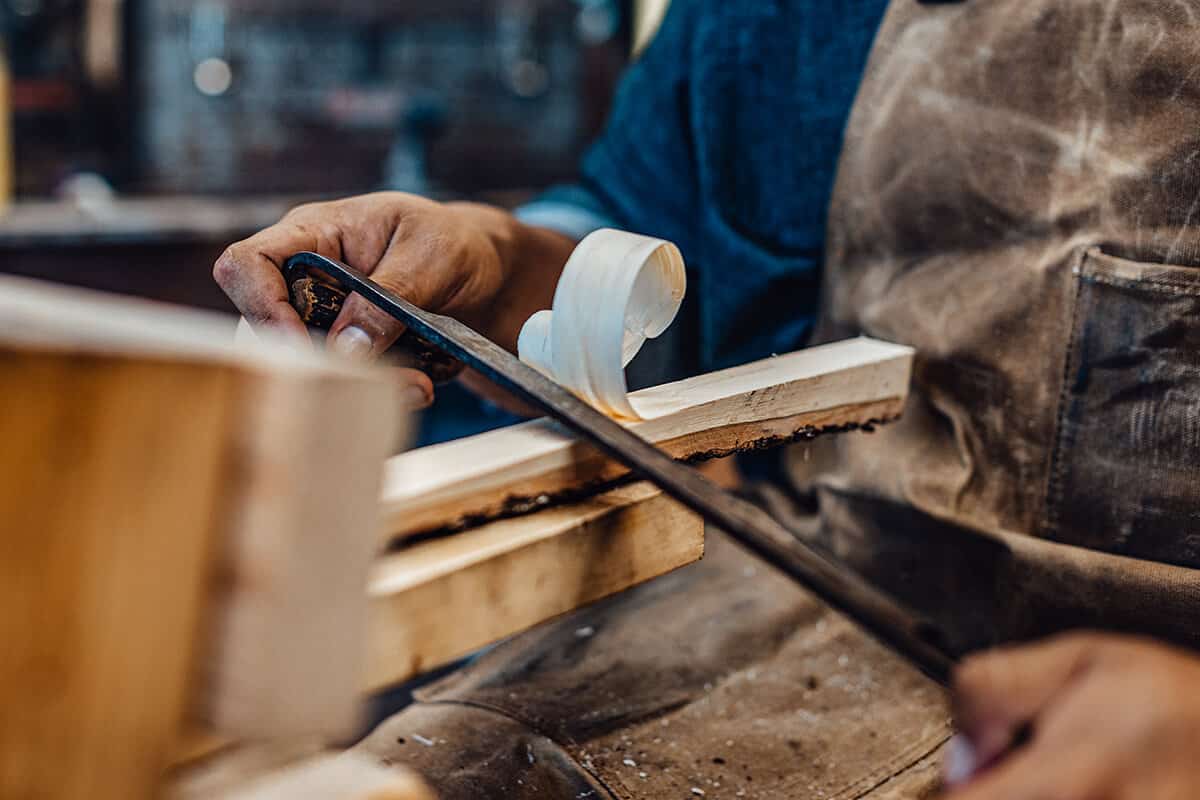 Brenner Billy carving a stickball stick