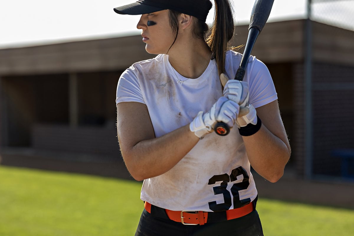 Michaela Richbourg holds a bat in her OSU training uniform