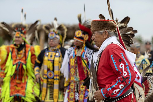 Wilson Roberts walks before a group of other Choctaw natives in traditional dress