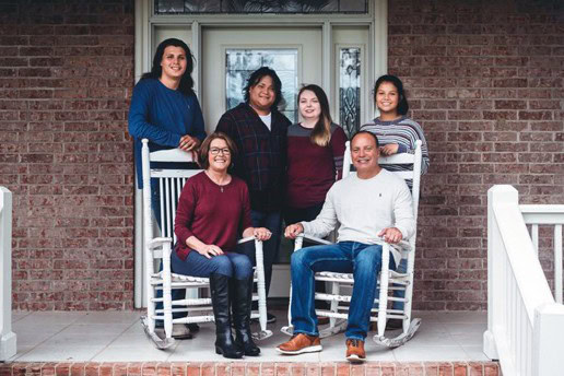 Chief Gary Batton and his family pose for a picture on the front porch of their home.