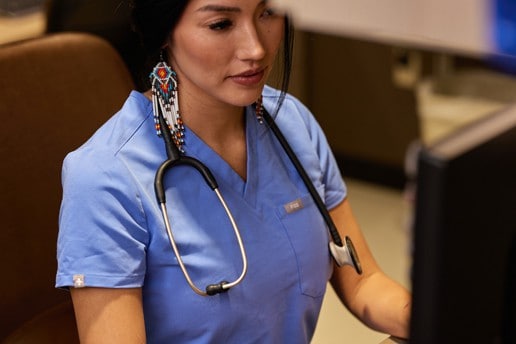 Tara Thorpe works on a computer at her desk