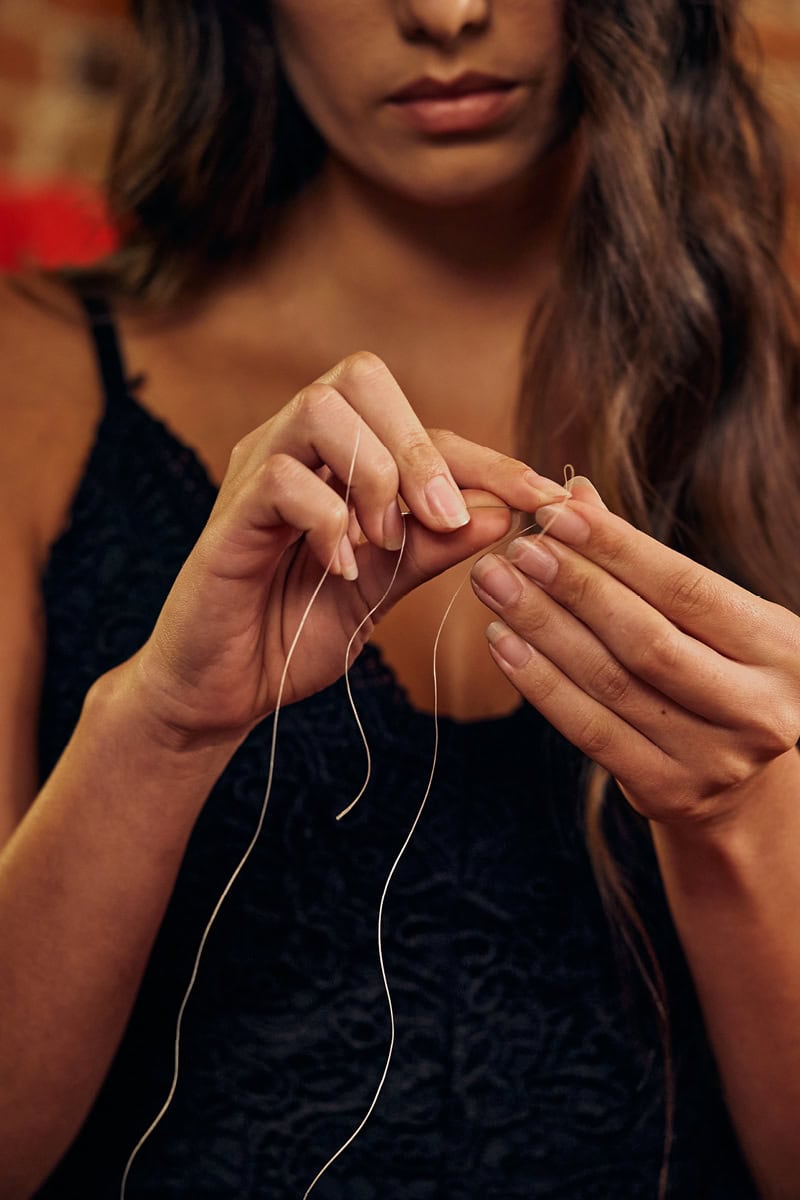 Jula Harjo threads beads together