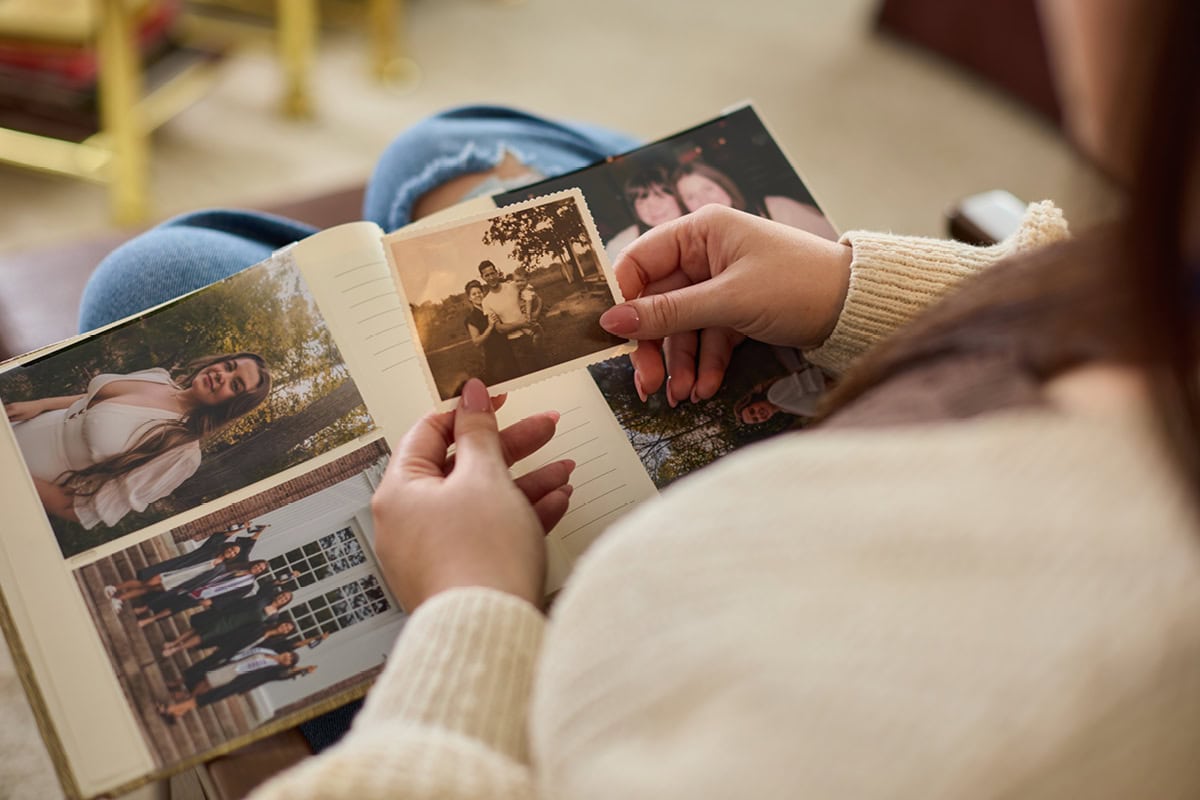 Claire Young holds an old photo from her scrapbook