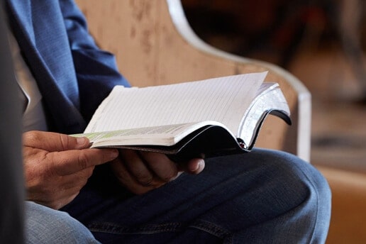 Mike Mings looks over his notes, tucked away inside his Bible