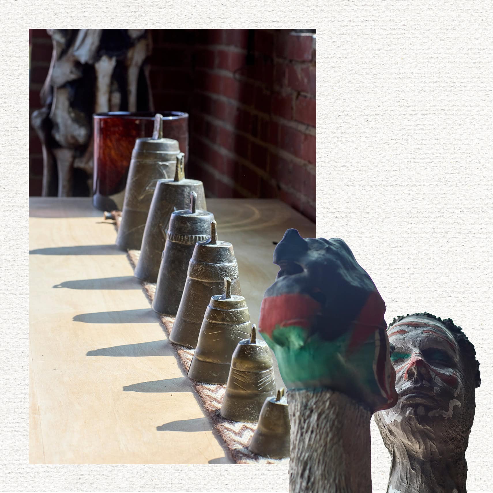 A set of bells in a row and two sculptures