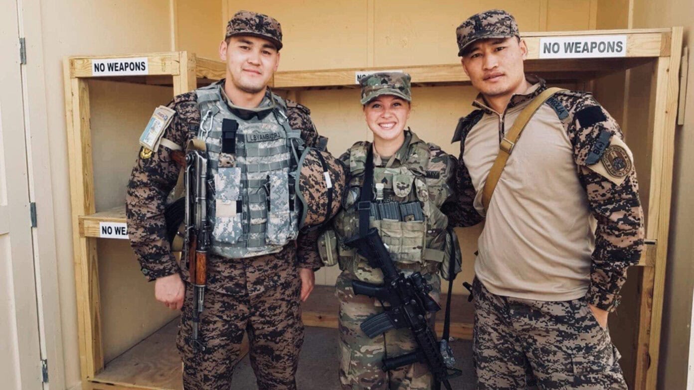 Military personnel posing together at a training or deployment site.