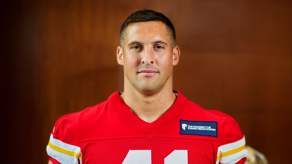Profile view of James Winchester wearing his Chiefs Jersey.