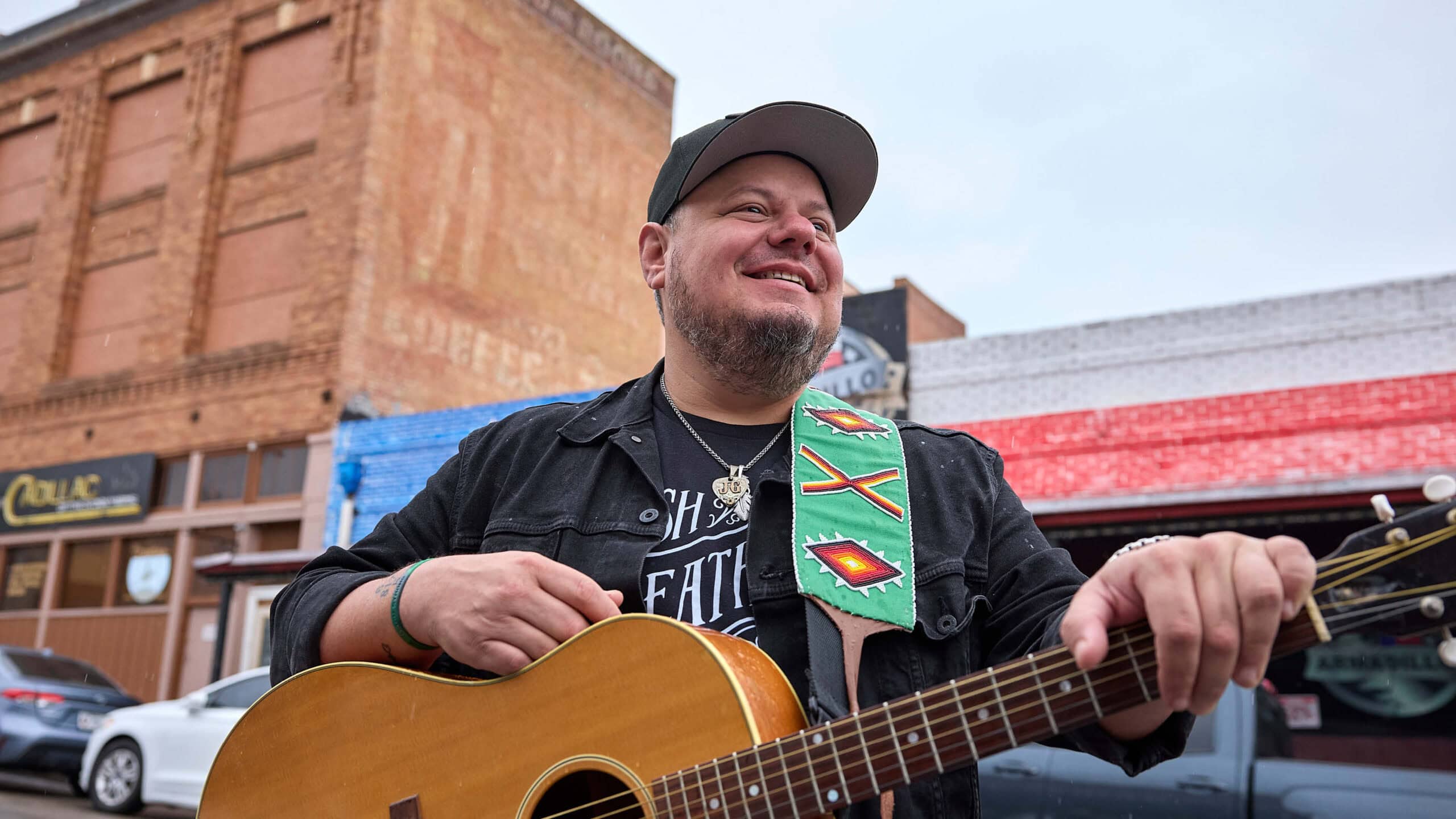 Joey Green with his guitar in front of Cadillac Bar in Stockyards, Fort Worth